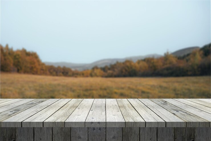Photo wooden table against a blurred autumn landscape
