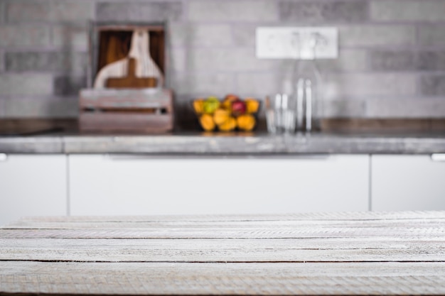 Wooden table on background of kitchen room. Place for object, text.