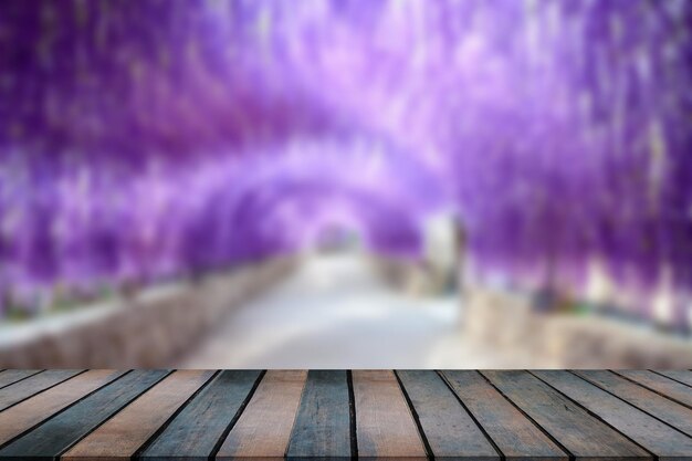 Photo wooden table beautiful purple flower tunnel.