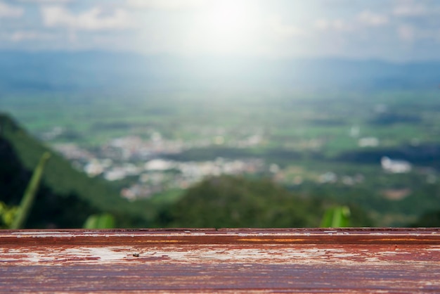 Wooden table and beauty blur sky and mountains as background