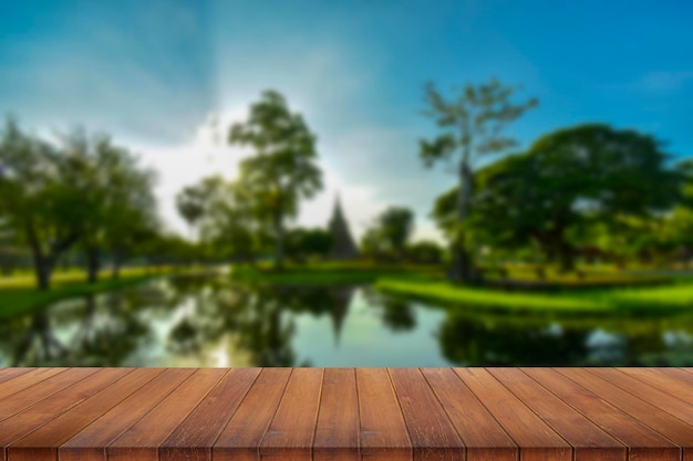 Wooden table and blur of beauty on sunset day and Thai templexA