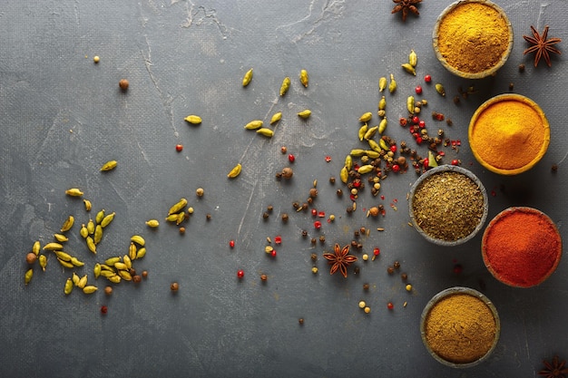 Wooden table of colorful spices Darkbackground Top view