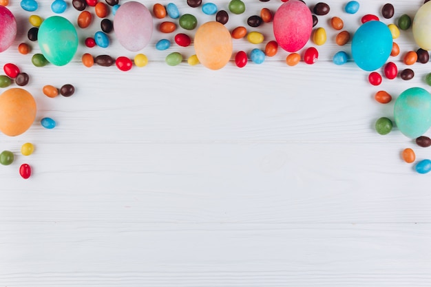 Wooden table to Easter around eggs and candy.