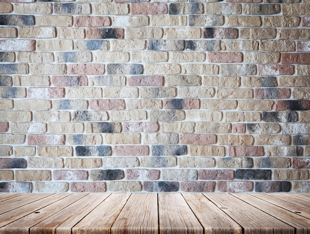 Wooden table in front of brick wall