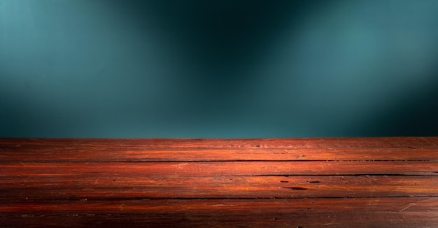 Wooden table in front of rustic wall with empty copy space