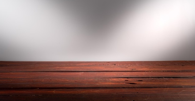 Wooden table in front of rustic wall with empty copy space