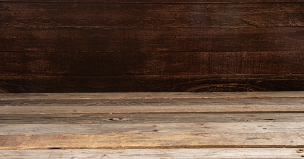 Wooden table in front of rustic wall with empty copy space