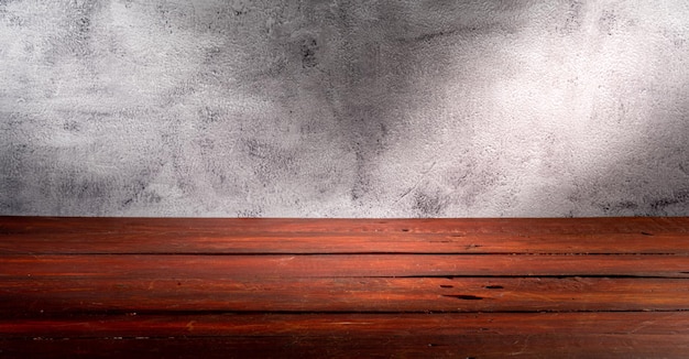 Wooden table in front of rustic wall with empty copy space