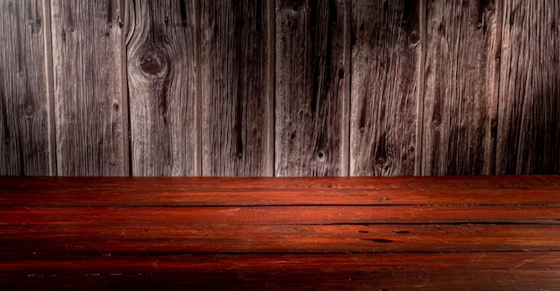 Wooden table in front of rustic wall with empty copy space