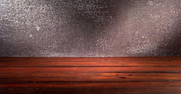 Wooden table in front of rustic wall with empty copy space