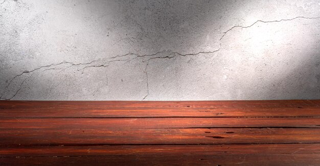 Wooden table in front of rustic wall with empty copy space