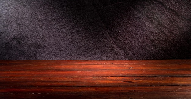 Photo wooden table in front of rustic wall with empty copy space