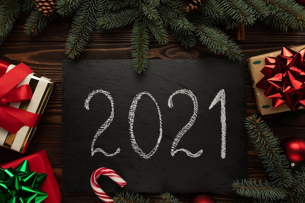 Photo on a wooden table is a black board with the words