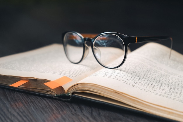 On the wooden table is an open book