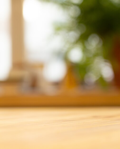 Wooden table near the blurred window in the living room