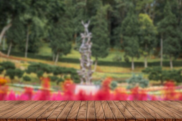 Wooden table top on blurred park background