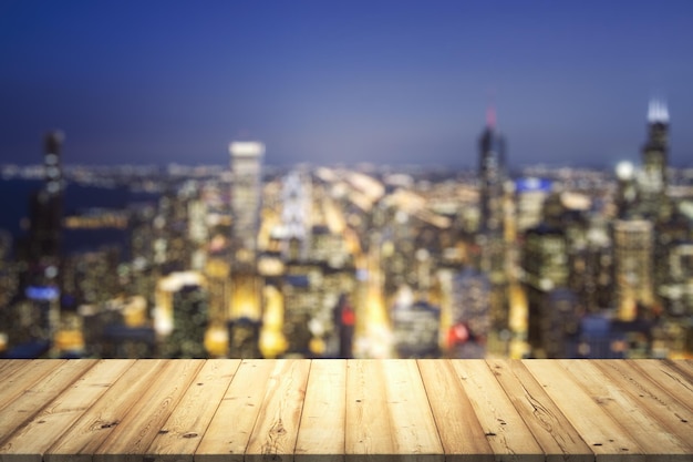 Wooden table top with beautiful blurry skyline at night on background mockup