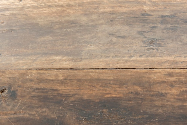 Wooden table top with two planks of dark color and used with patina of vintage object