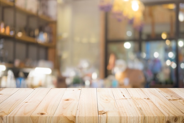 Wooden table with blur background of coffee shop