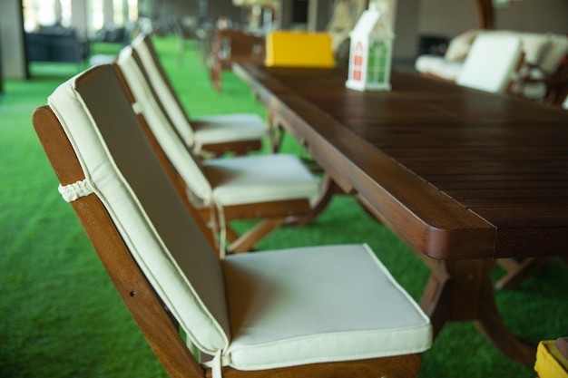 A wooden table with chairs and a box of milk on it