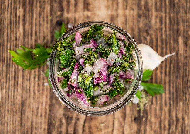 Photo wooden table with chimichurri detailed closeup shot selective focus