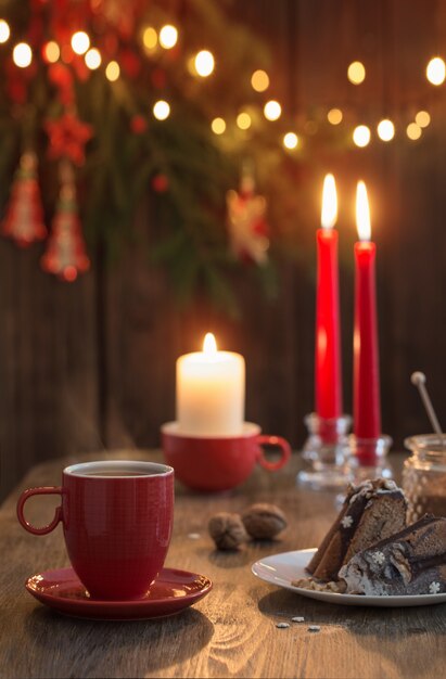 Wooden table with Christmas cake and decor