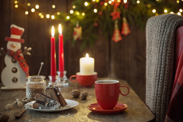 Wooden table with Christmas cake and decor