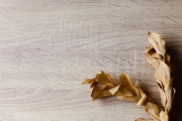 A wooden table with dried flowers on it