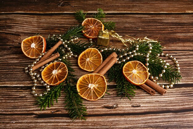 Wooden table with dried orange slices and cinnamon for Christmas