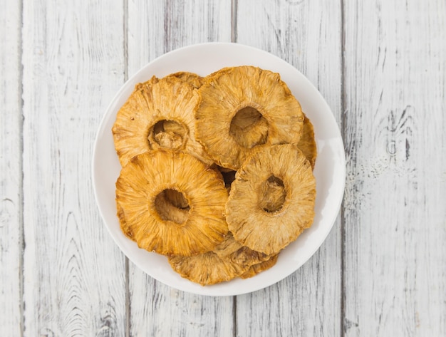 Wooden table with Dried Pineapple Rings selective focus