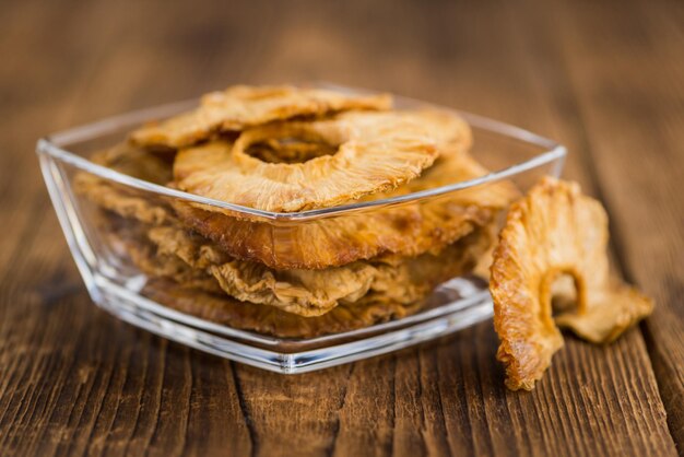 Wooden table with Dried Pineapple Rings selective focus