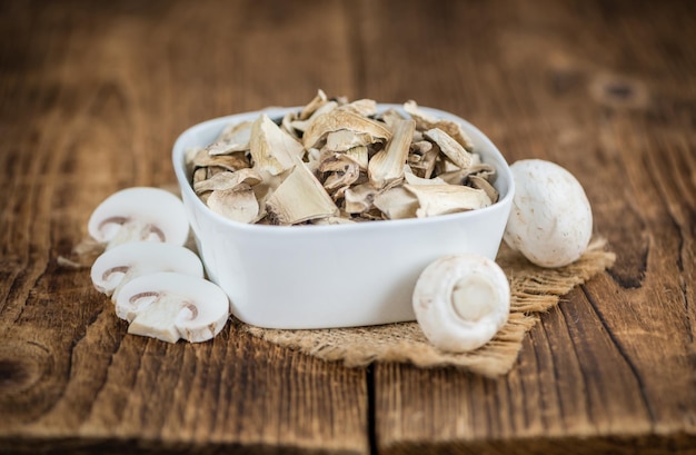 Wooden table with Dried white Mushrooms selective focus