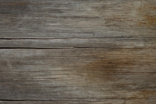 A wooden table with a gray and brown background and a white shoe on it.