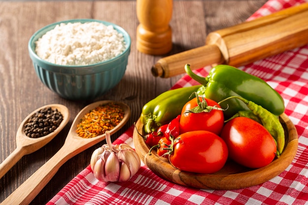 Wooden table with ingredients for pizza