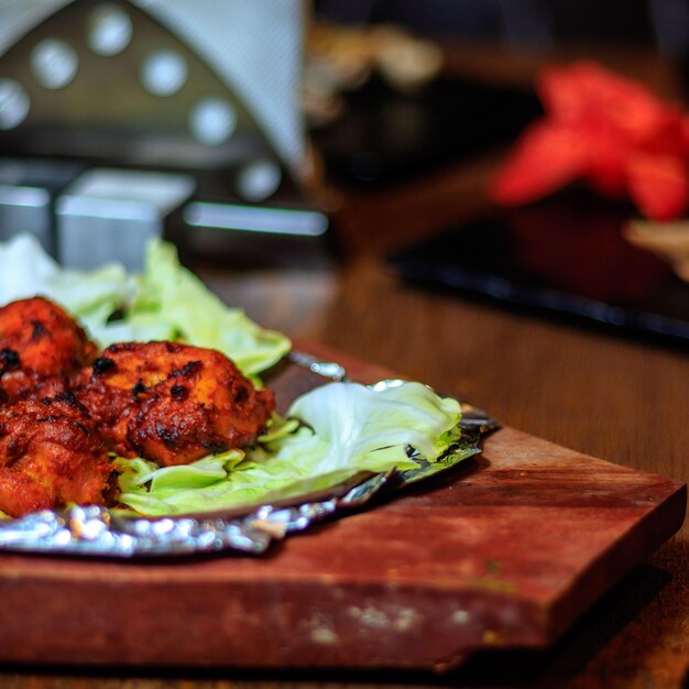 A wooden table with a piece of food on it and a piece of paper on it.