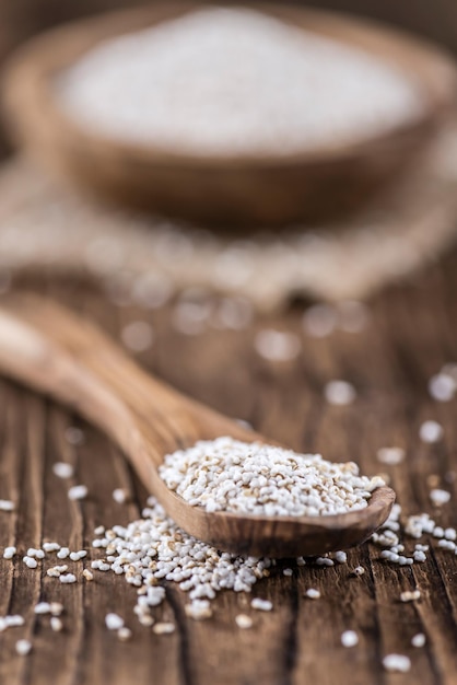 Wooden table with a portion of puffed Amaranth selective focus