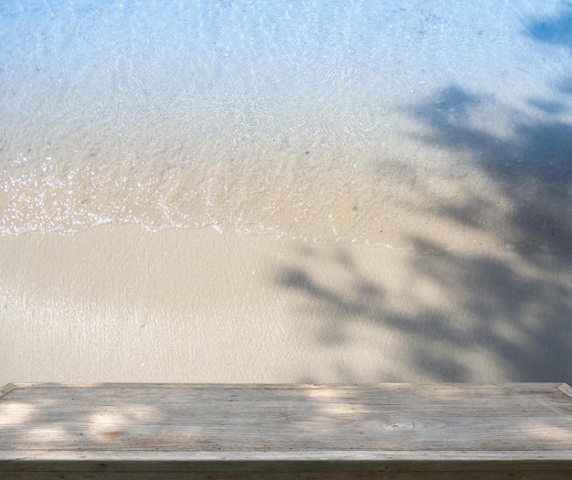 A wooden table with a shadow of a tree on it.