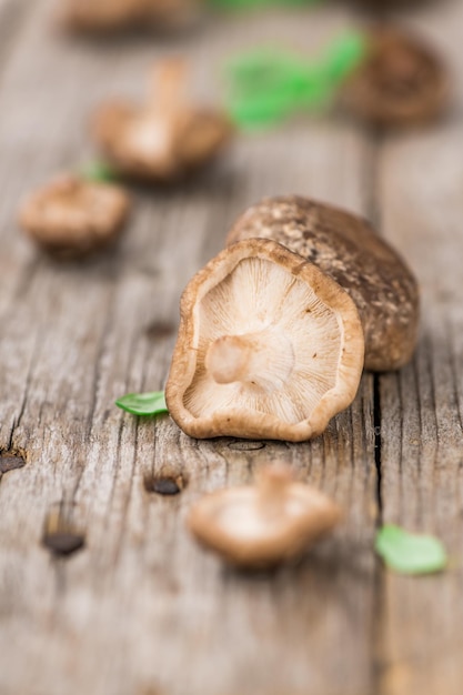 Wooden table with Shiitake mushrooms selective focus