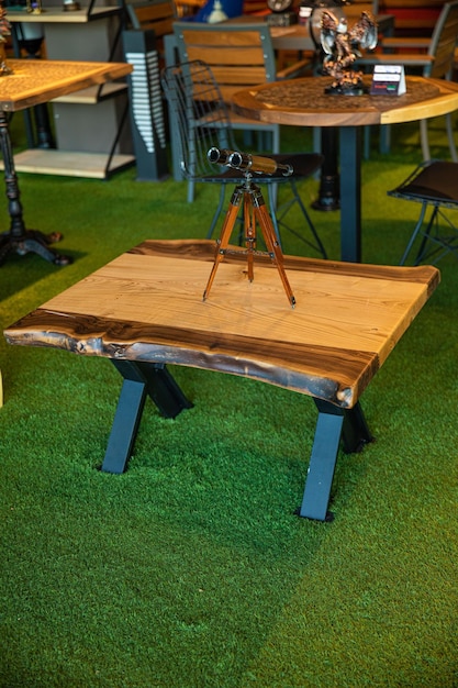 A wooden table with a tripod on it and a tripod on it.