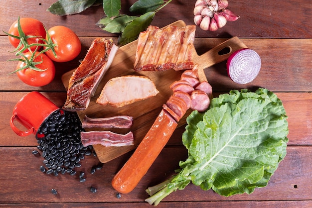 A wooden table with vegetables and meats on it