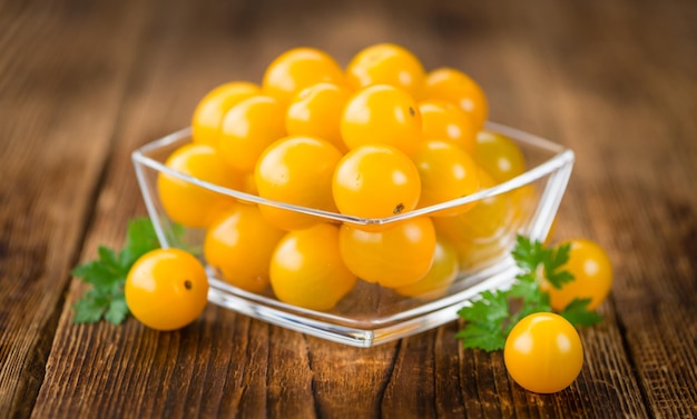 Wooden table with Yellow Tomatoes selective focus