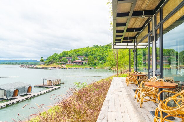 wooden tables and chairs in restaurant by a lake