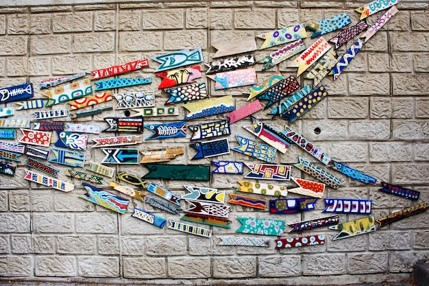 Wooden tag painting or art wood label fish format on stone wall in Gamcheon Culture Village or Santorini of Pusan for korean people travelers travel visit on February 18 2023 in Busan South Korea