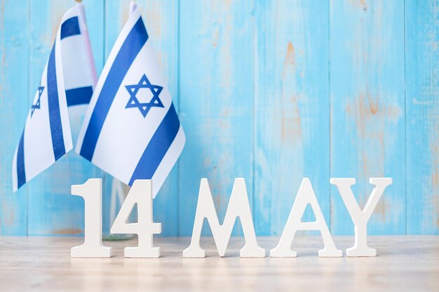 Photo wooden text of may 14th with israel flags israel independence day and happy celebration concepts