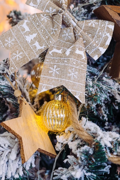 Wooden textile and glass toys on the Christmas tree  bow star ball closeup