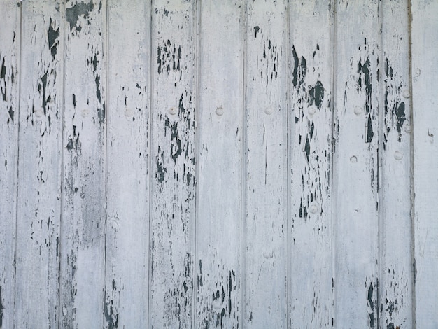 Wooden texture background surface with cracked white paint.