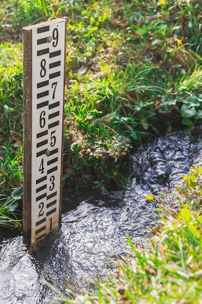 Wooden tide gauge in a stream in Slovenia