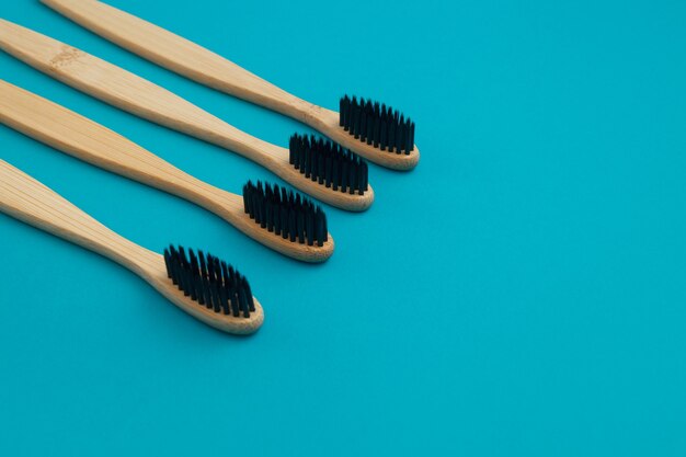 Wooden toothbrush on blue background