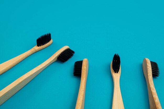 Wooden toothbrush on blue background