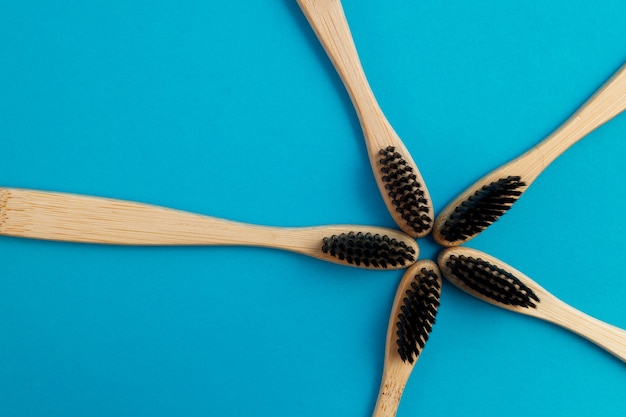 Wooden toothbrush on blue background